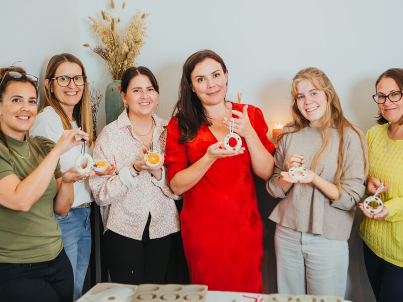 Women holding handmade Christmas decoration
